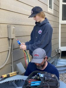 Image of two Better Built Heating and Cooling techs repairing an HVAC unit in parker CO representing our HVAC Services in the southeast Denver areas.