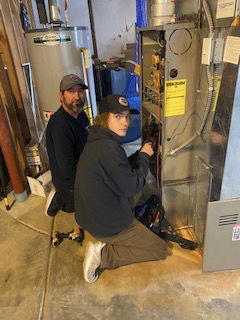 an image of two hvac technicians completing a tune-up.
